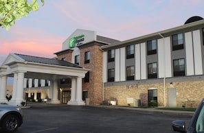 A hotel with a brick facade, a covered entrance, and a sign for the Hampton Inn Express.
