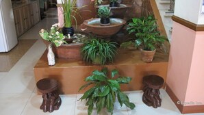 A staircase with multiple potted plants and a small fountain. - Sea Jewel Beach Resort Puerto Galera (Puerto Galera)
