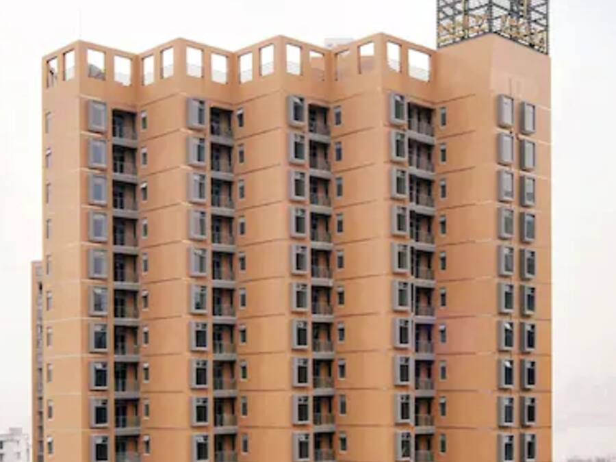 A high-rise building with multiple balconies and a unique architectural design.
