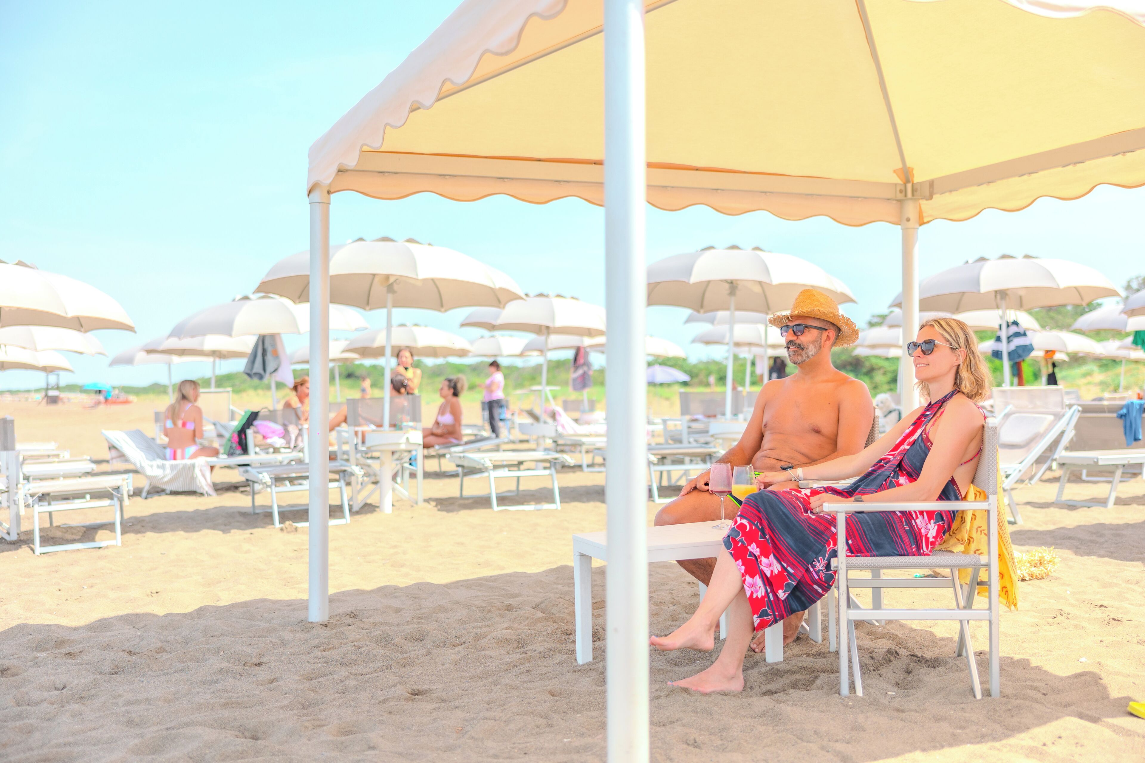 A beach with sun loungers and umbrellas.