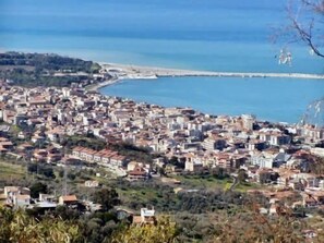 A coastal town with dense housing, a beach, and a pier. - Hotel Palazzo Fortunato (Sant'Agata di Militello)