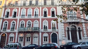 A multi-story building with arched windows and balconies.