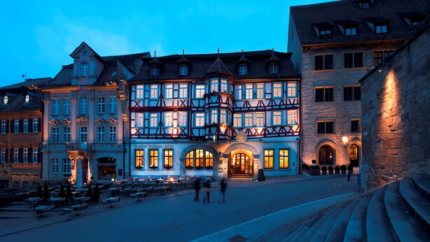 A historic building with multiple stories, large windows, and a prominent corner turret. - Hotel Gasthof Goldener Adler (Schwäbisch Hall)