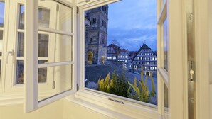 A window with an open view of a historic building with a clock tower and traditional architecture. - Hotel Gasthof Goldener Adler (Schwäbisch Hall)