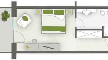 Plano de planta que muestra una cama, mesita de noche, lámpara y una pequeña zona de estar con una silla y una mesa.