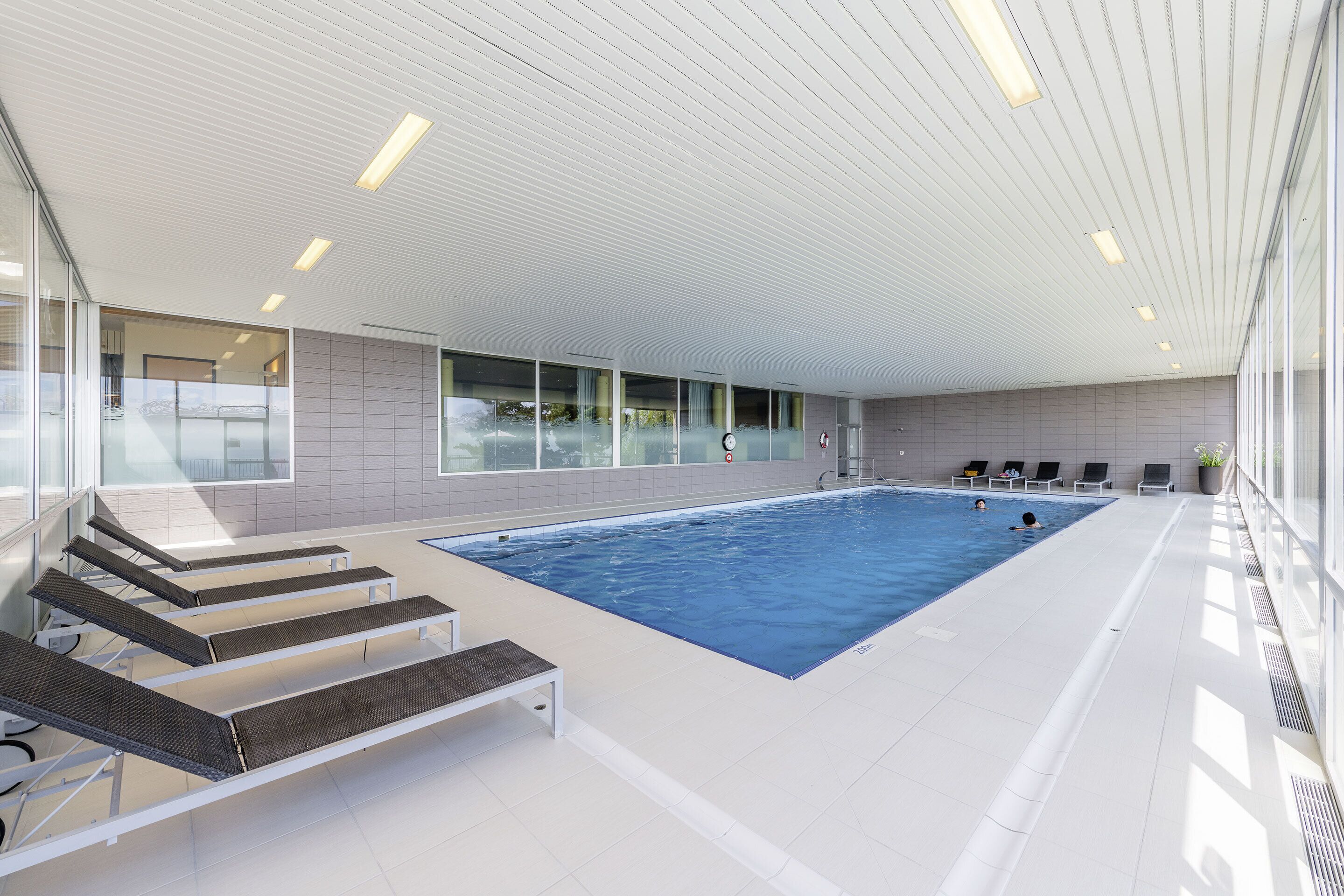 indoor pool, pool umbrellas, pool loungers