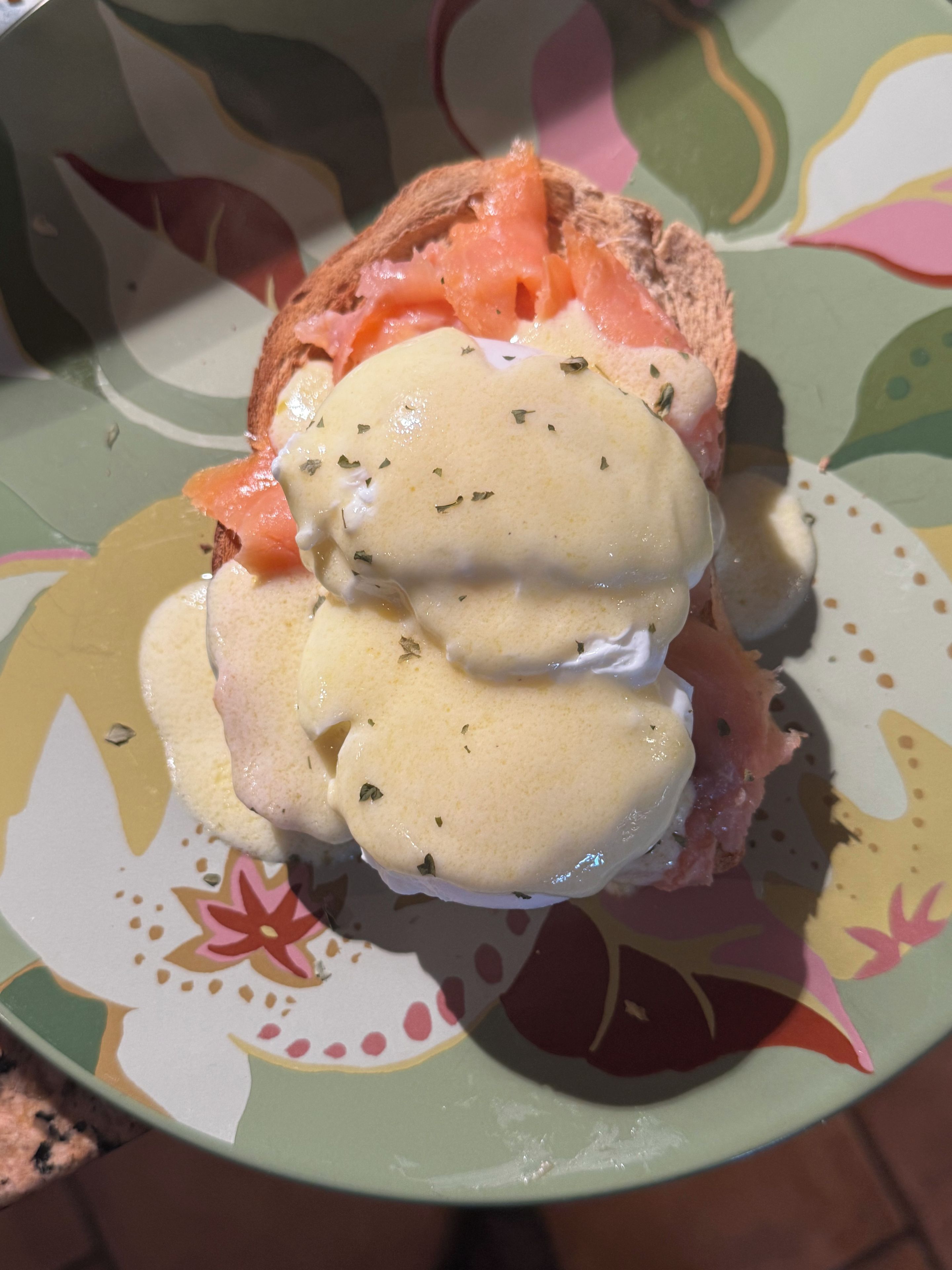 A plate with a sandwich and a creamy sauce.