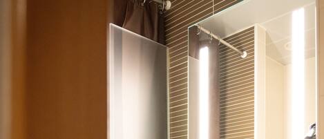 A bathroom with a sink, mirror, and shower curtain.