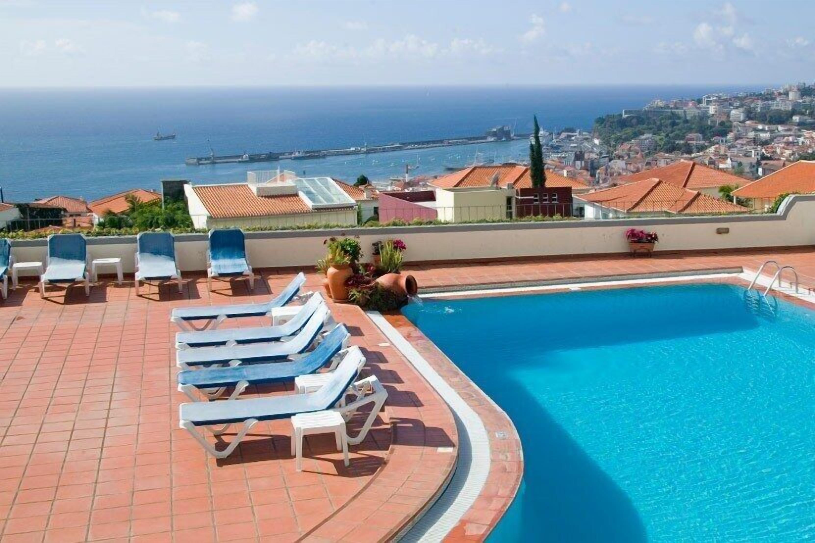 outdoor pool, pool umbrellas, pool loungers