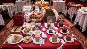 A buffet table with various food items and condiments.