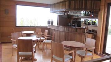 A bar area with wooden furniture and a large window.