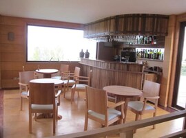 A bar area with wooden furniture and a large window.