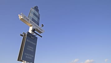 A signpost with directions to 'The Botany Bay Bar', 'Restaurant', 'Coffee Lounge', and 'Function Rooms'.