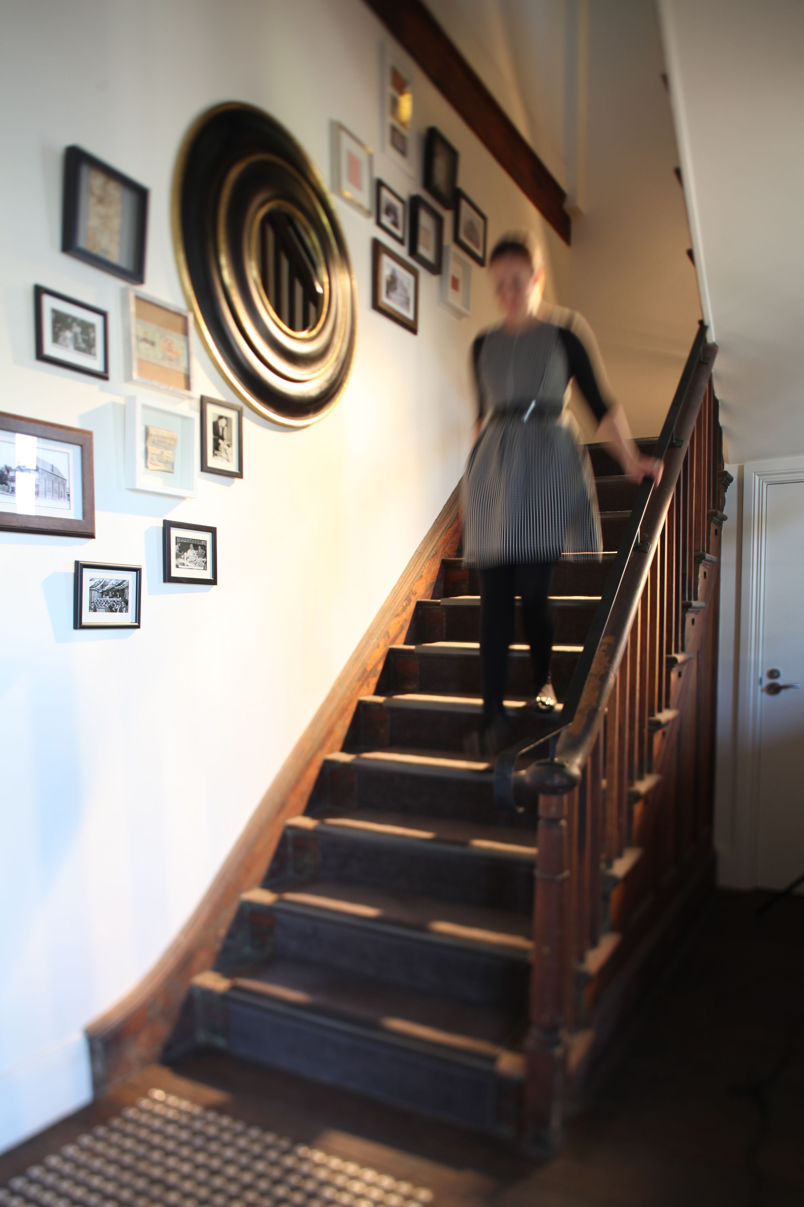 A staircase with wooden steps and a handrail, leading to a door at the top.