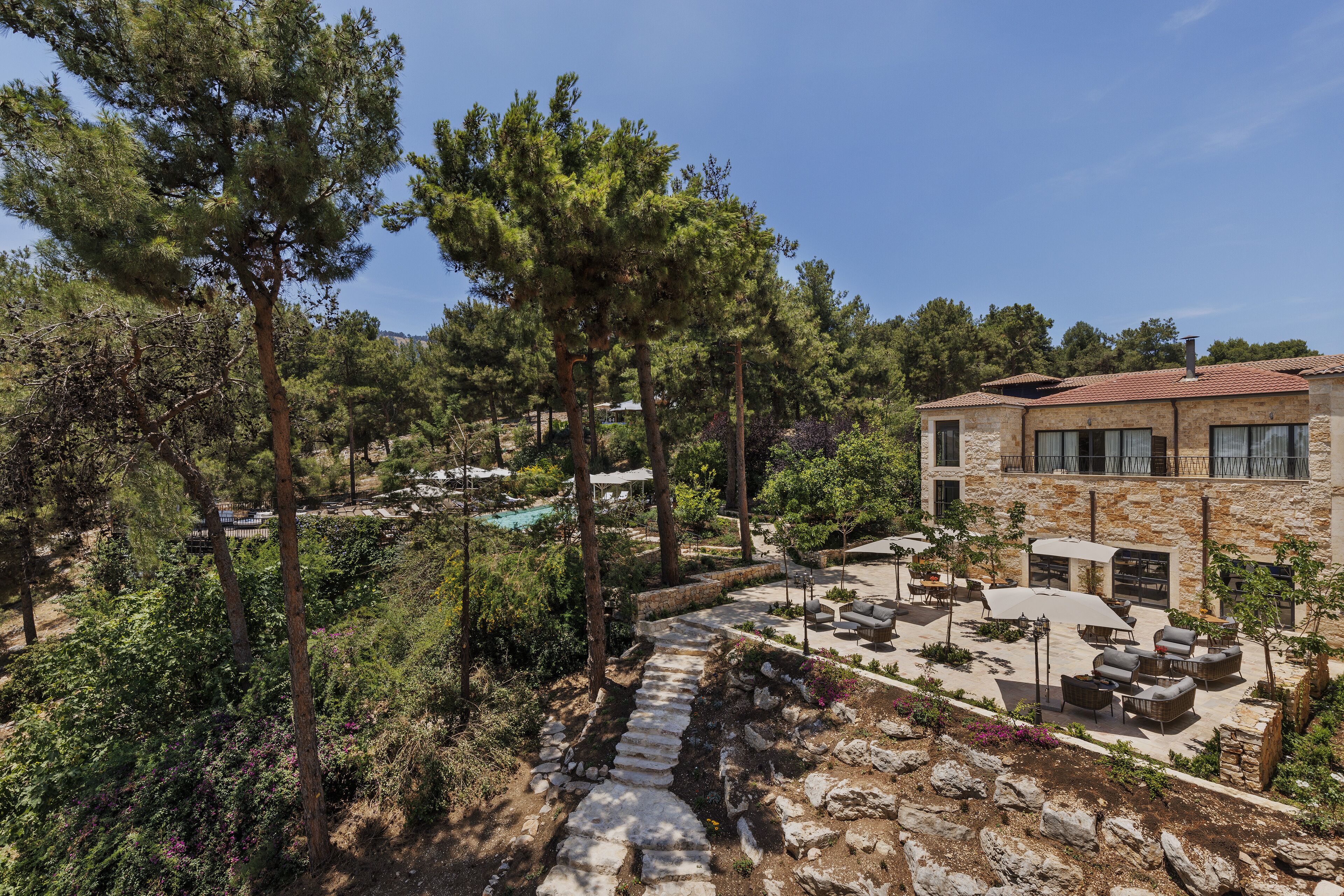 A stone building with outdoor seating and a stone pathway.