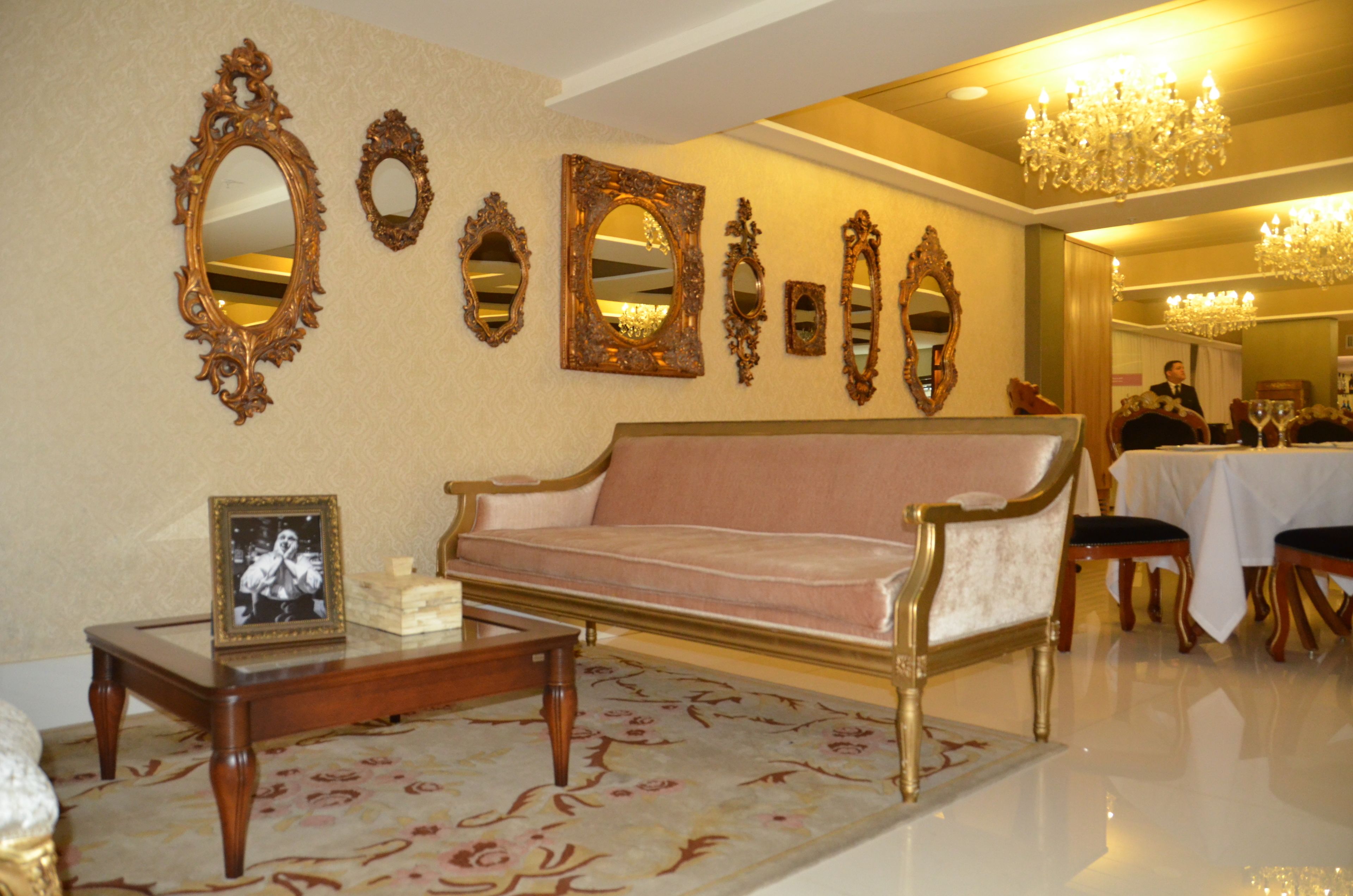 A room with a sofa, a coffee table, and a chandelier.