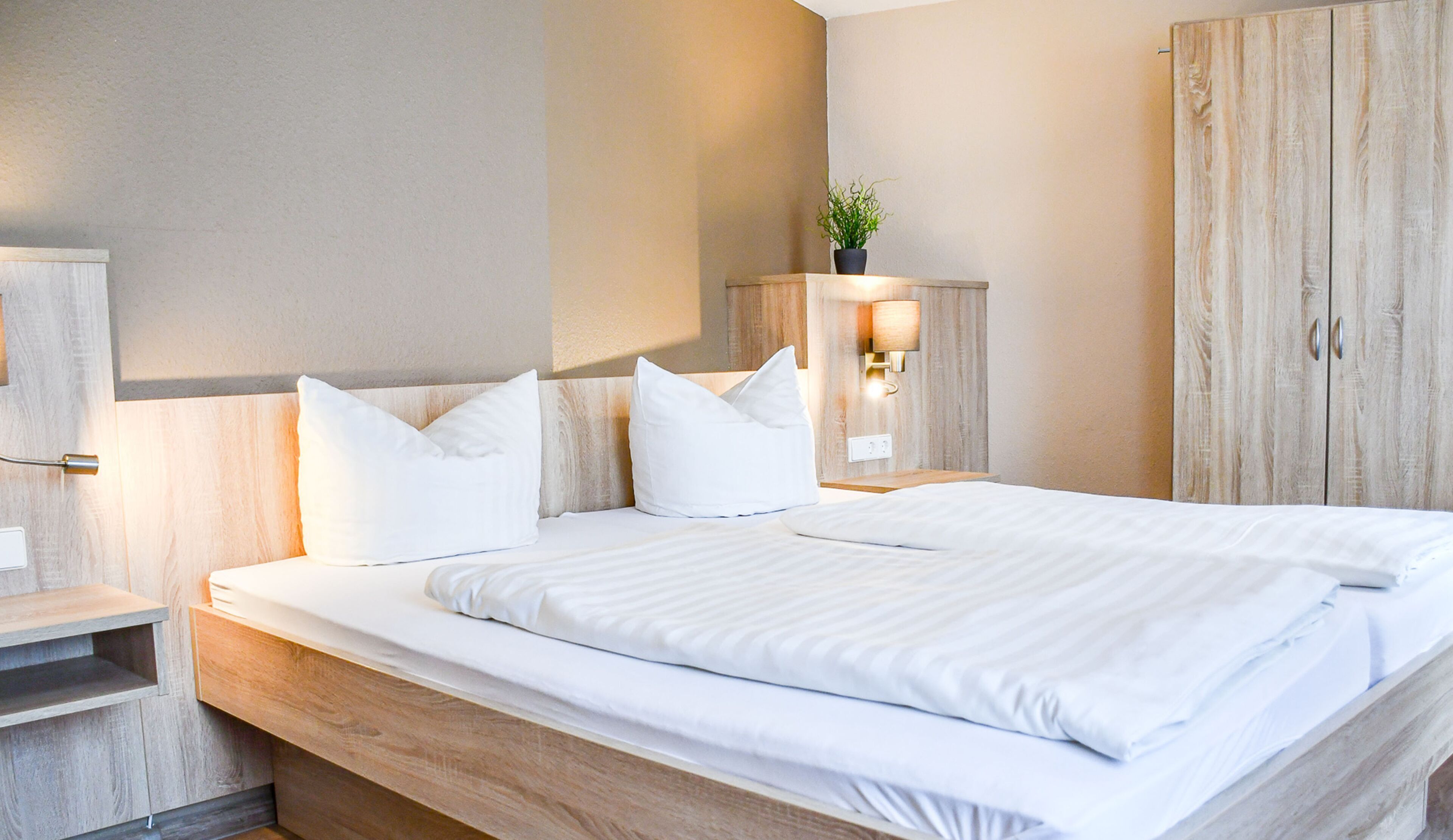 Hypo-allergenic bedding, desk, laptop workspace, blackout drapes