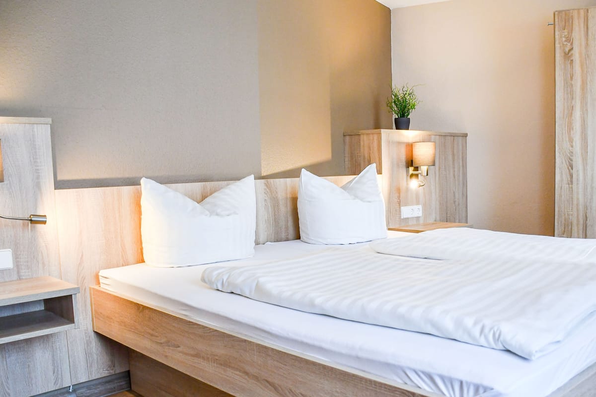 Hypo-allergenic bedding, desk, laptop workspace, blackout drapes