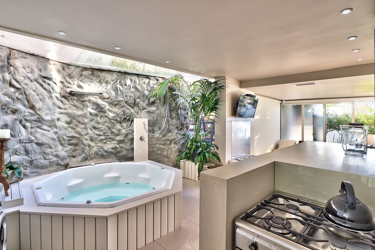 A modern kitchen with a gas stove, a built-in oven, and a large countertop.