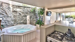 A modern kitchen with a gas stove, a built-in oven, and a large countertop. - Clifton Bungalow (Cape Town)