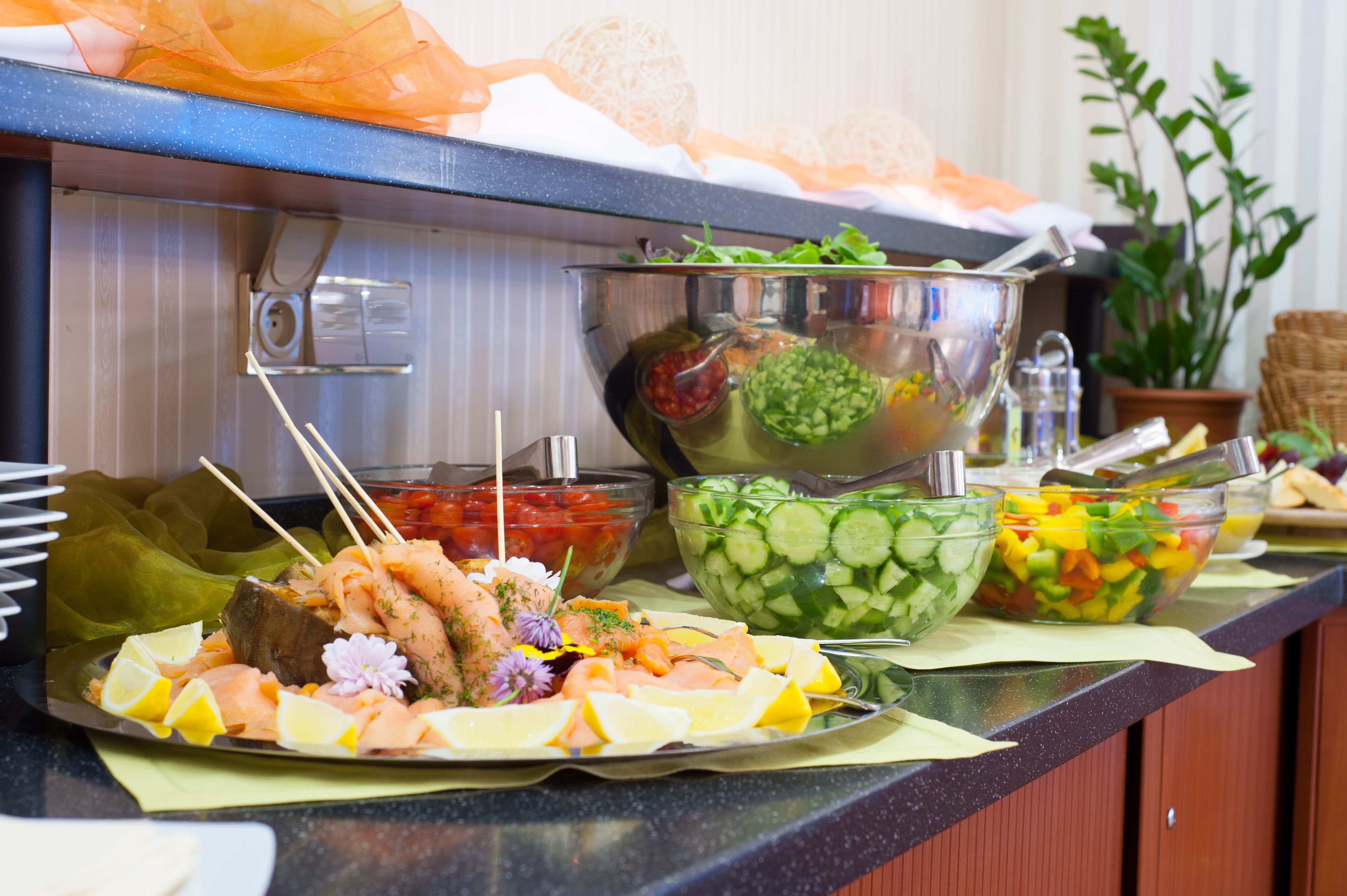 A buffet with various dishes including seafood, salads, and vegetables.