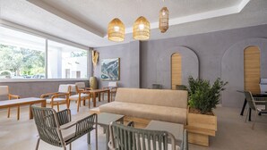 A modern interior with a sofa, chairs, and a dining area. - Petunya Beach Resort - All Inclusive (Bodrum)