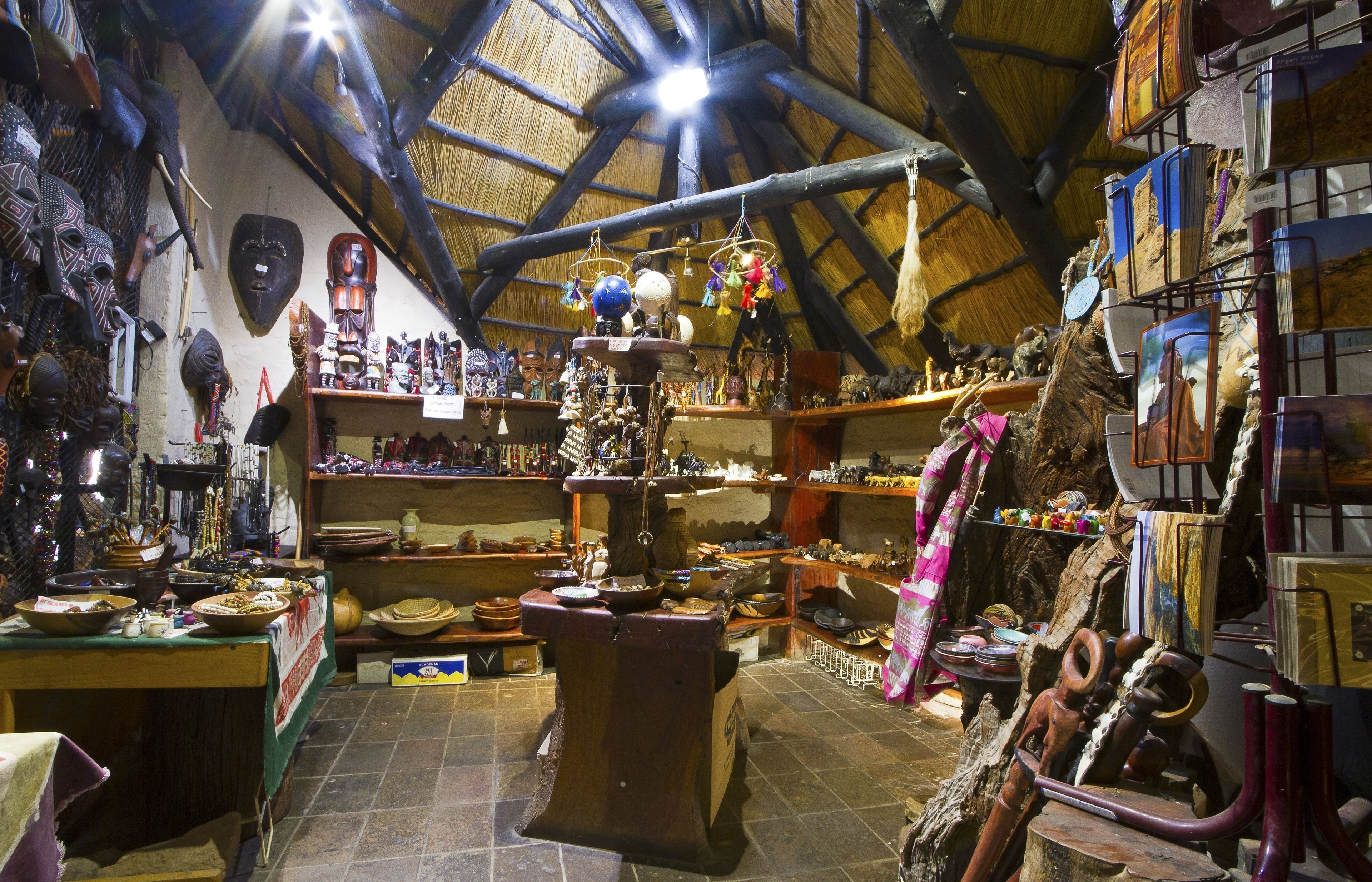 A traditional market with wooden shelves, pottery, and various handcrafted items.