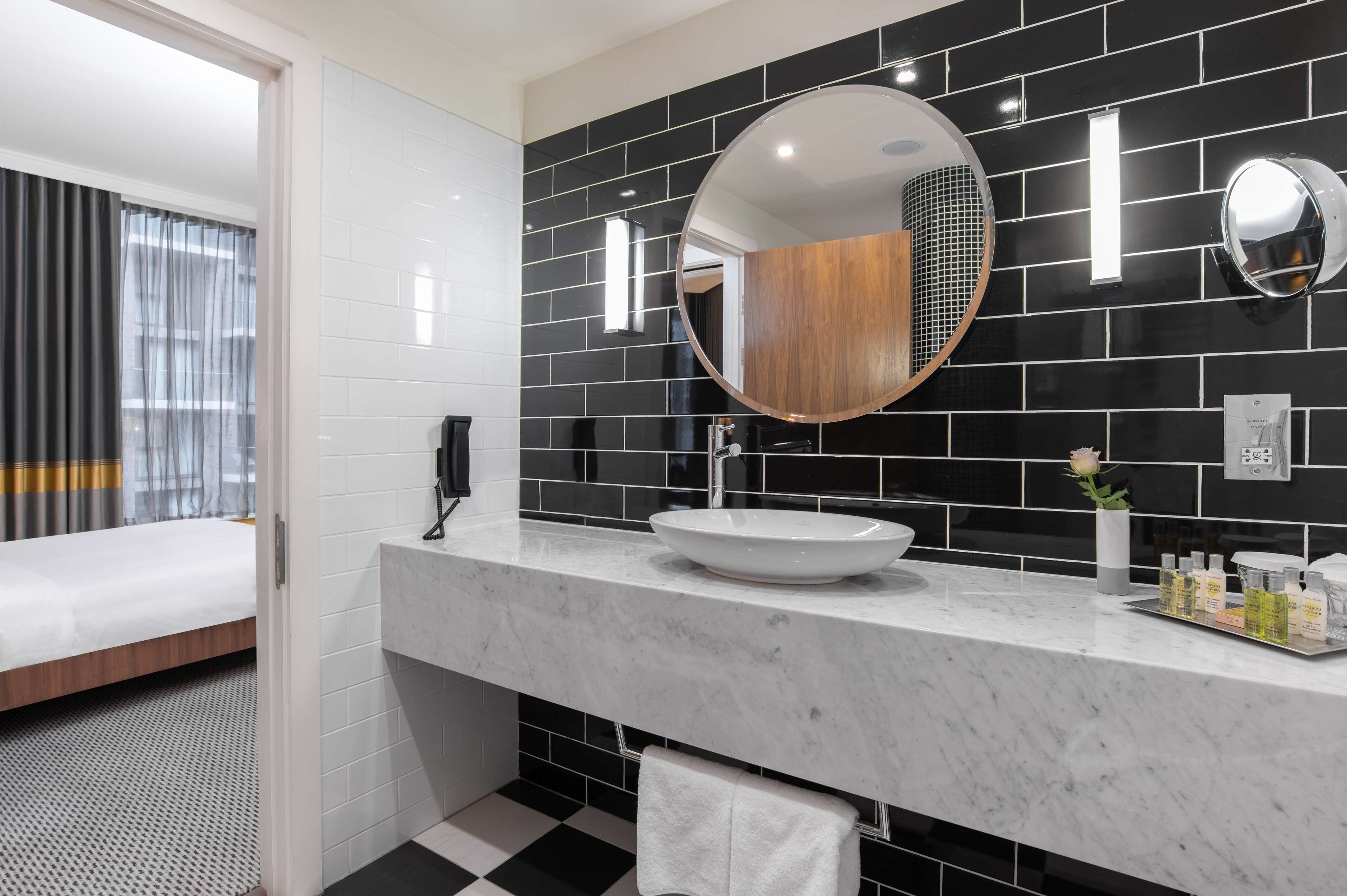 suite, 1 king bed, corner (living room) | bathroom | designer toiletries, hair dryer, towels