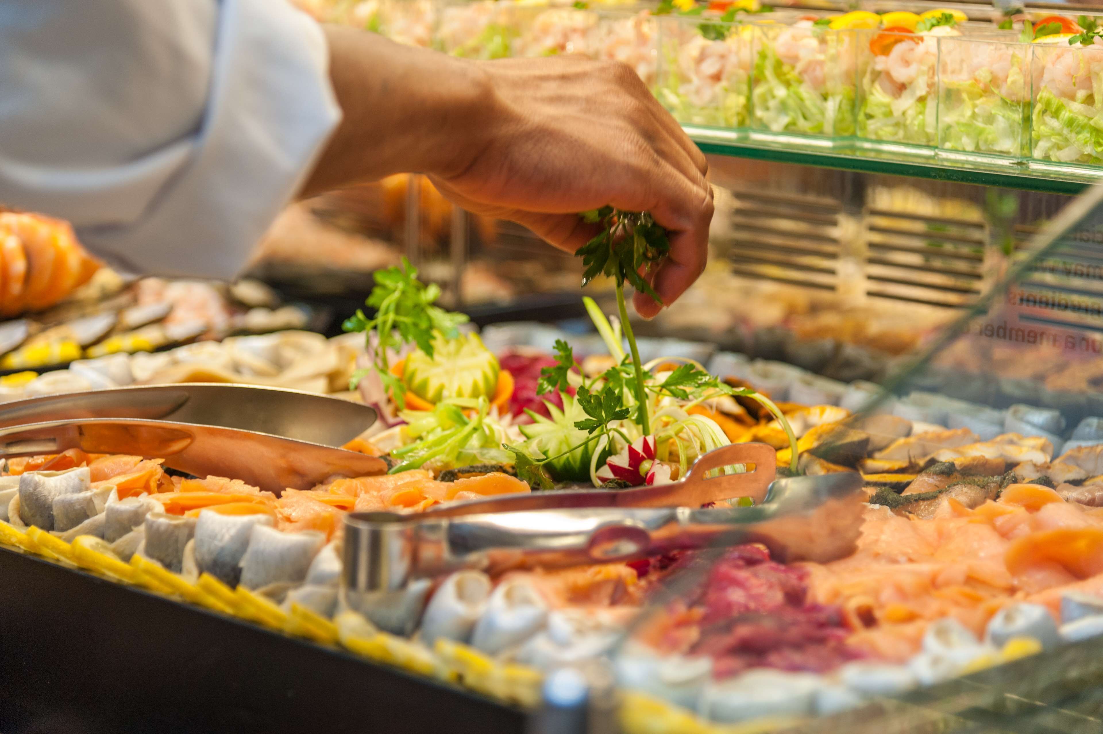 A buffet with various food items including seafood, vegetables, and salads.