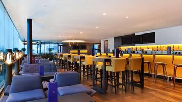 A modern bar area with seating and a bar counter.