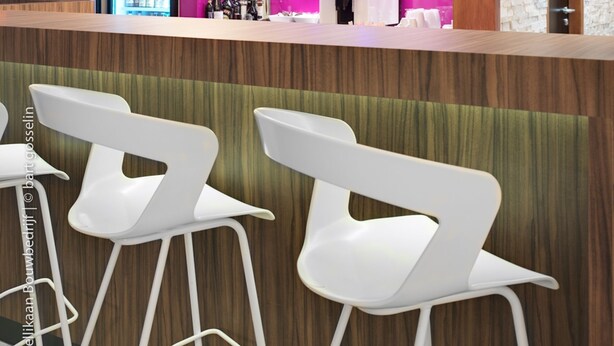 A modern bar area with a wooden counter, white bar stools, and a pink-lit background. - Best Western Hotel Brussels South (Sint-Pieters-Leeuw)
