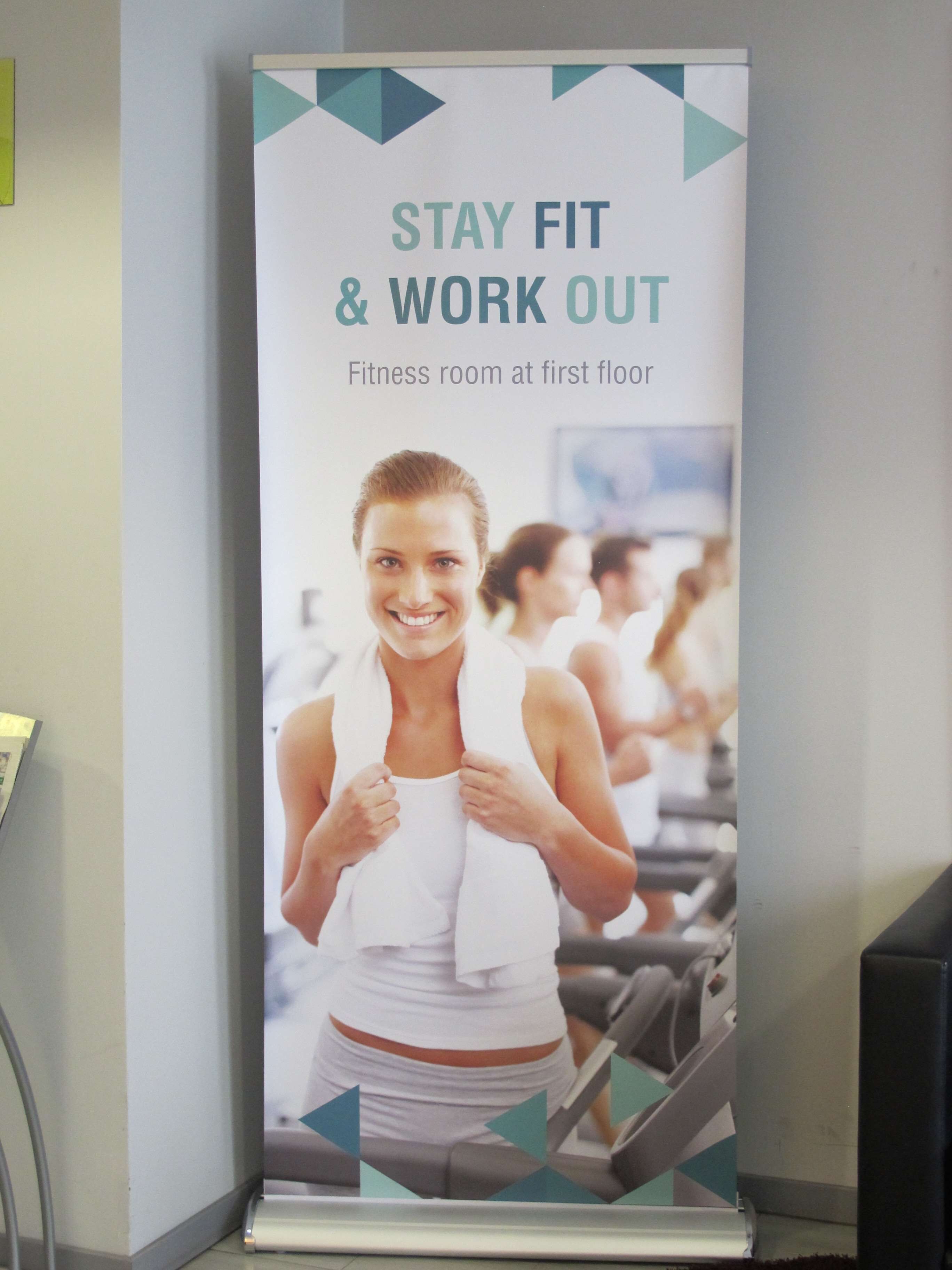 A poster advertising a fitness room on the first floor.
