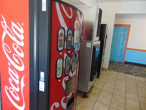 Vending machines with Coca-Cola branding, a blue door, and tiled flooring. - Best Western Lubbock Inn (Lubbock)
