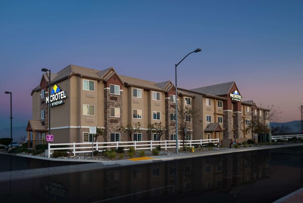 A multi-story hotel with a prominent sign for 'M Crotel Wyndham by Wyndham'.