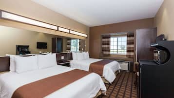 A hotel room with two beds, a flat-screen TV, a minibar, and a window with curtains.