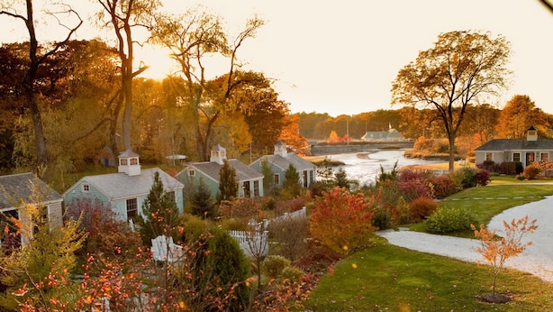 A residential area with houses, a river, and autumn foliage. - The Cottages at Cabot Cove (Kennebunkport)
