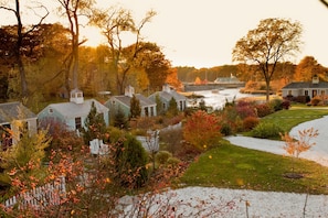 A residential area with houses, a river, and autumn foliage. - The Cottages at Cabot Cove (Kennebunkport)