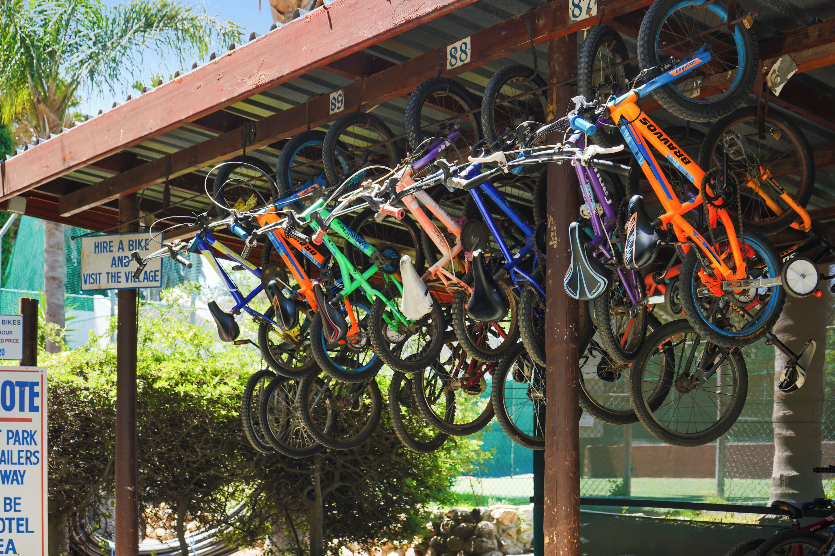 A bicycle rack with multiple bikes parked.