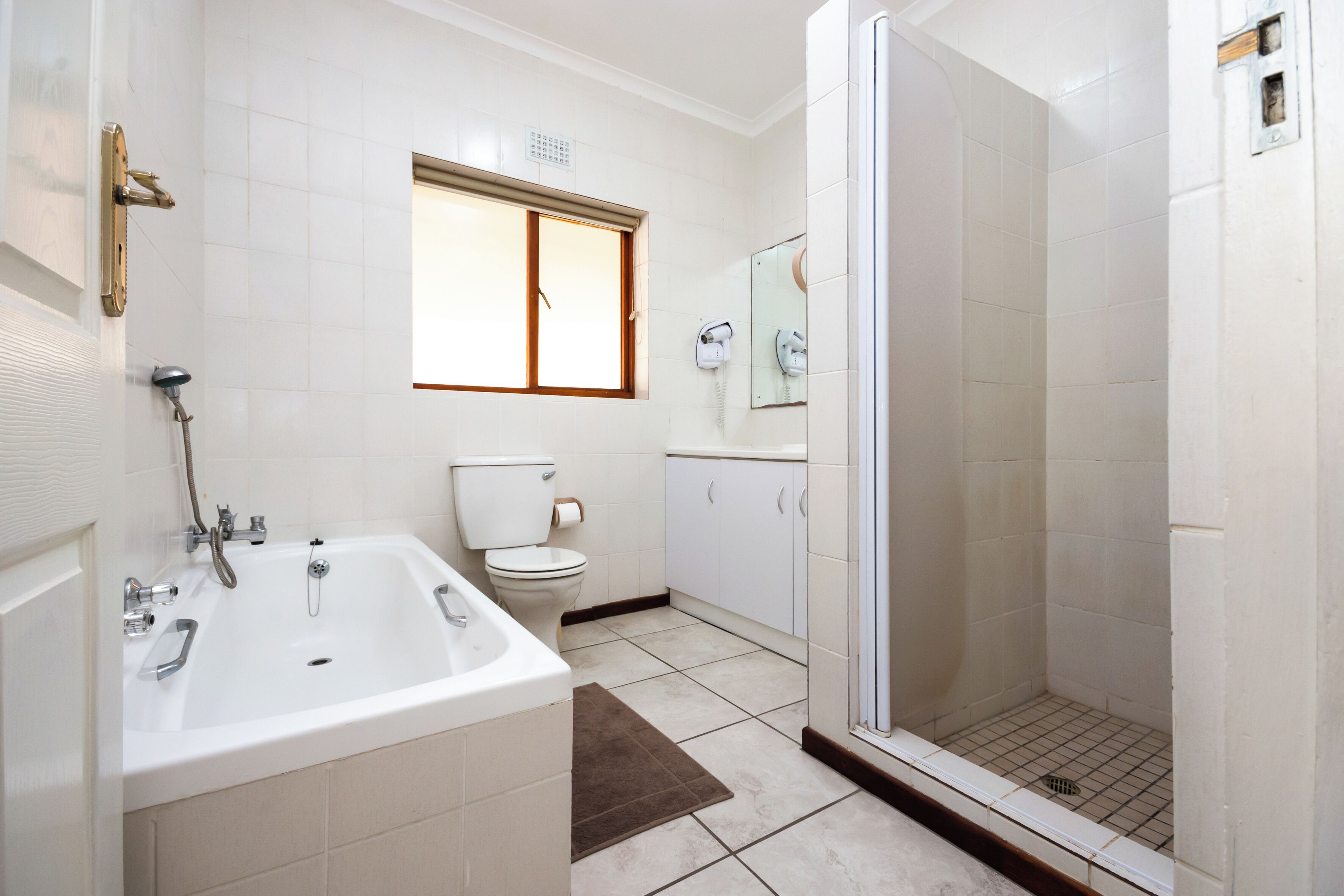 Un baño con bañera, inodoro y ducha.