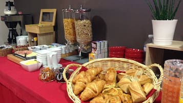 A breakfast buffet with various food items and beverages.