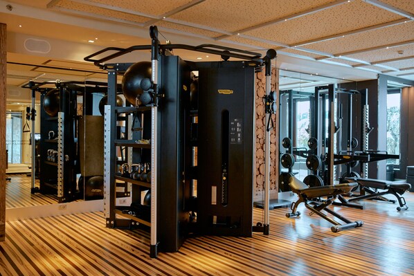 A gym with various exercise equipment, including weight machines and free weights. - Rosapetra Spa Resort (Cortina d'Ampezzo)