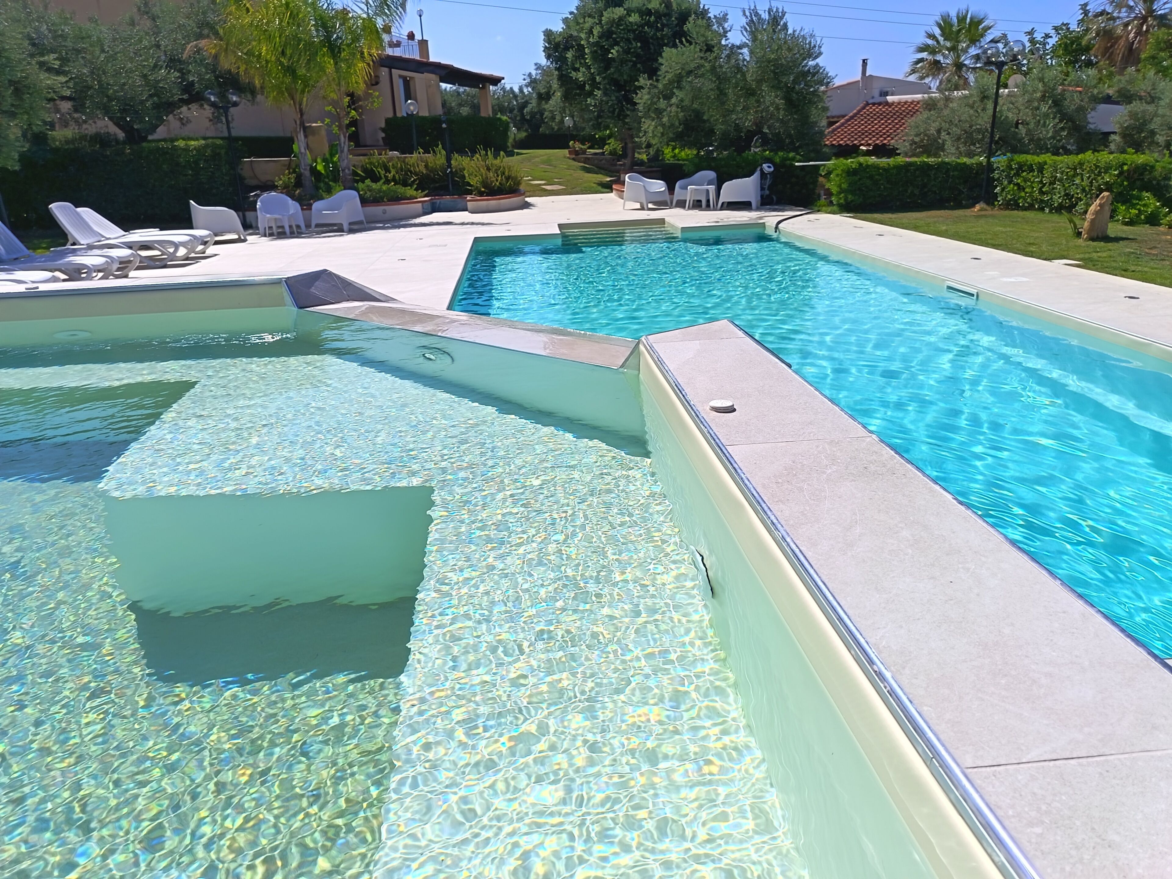 Seasonal outdoor pool, open 9 AM to 7:30 PM, pool umbrellas