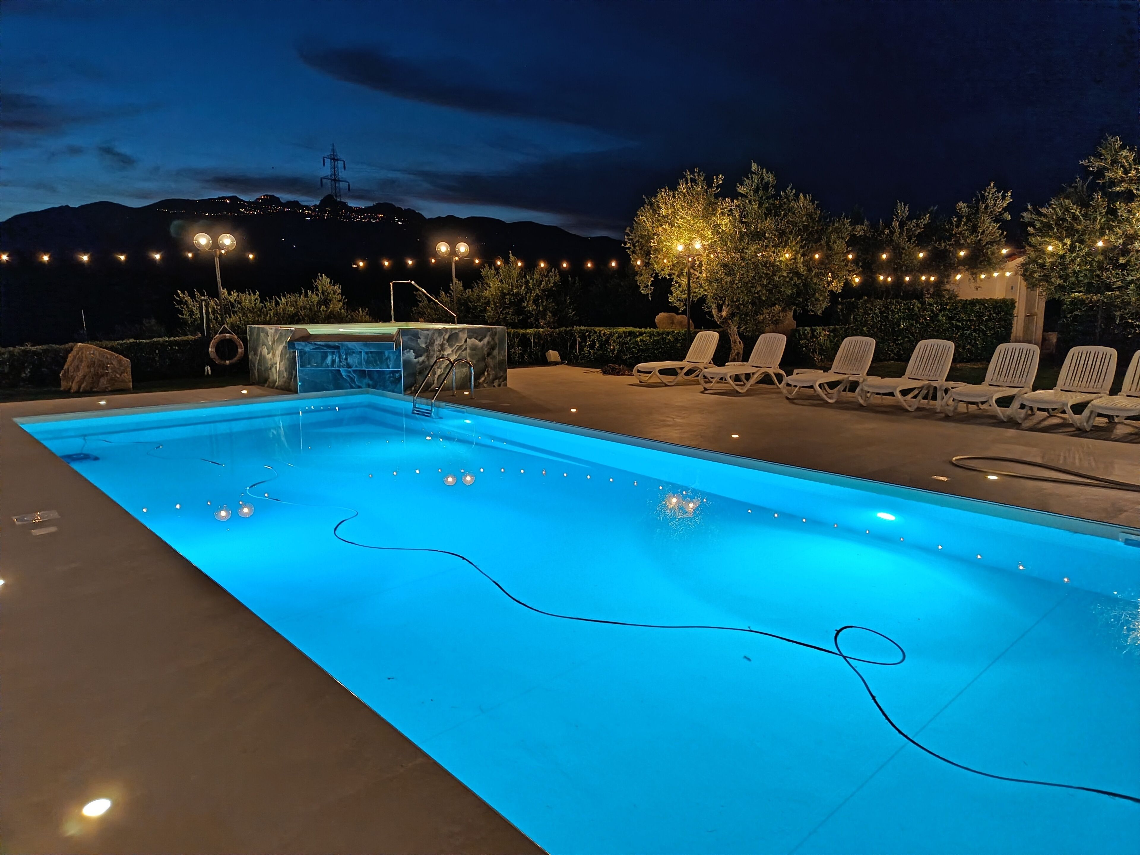 Seasonal outdoor pool, open 9 AM to 7:30 PM, pool umbrellas