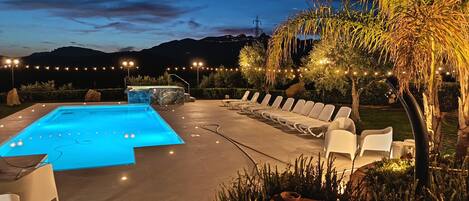 Seasonal outdoor pool, open 9 AM to 7:30 PM, pool umbrellas