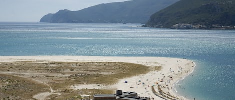 Na praia, areia branca, guarda-sóis, bar na praia 