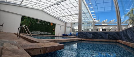 Indoor pool, open 7:00 AM to 10:00 PM, pool loungers