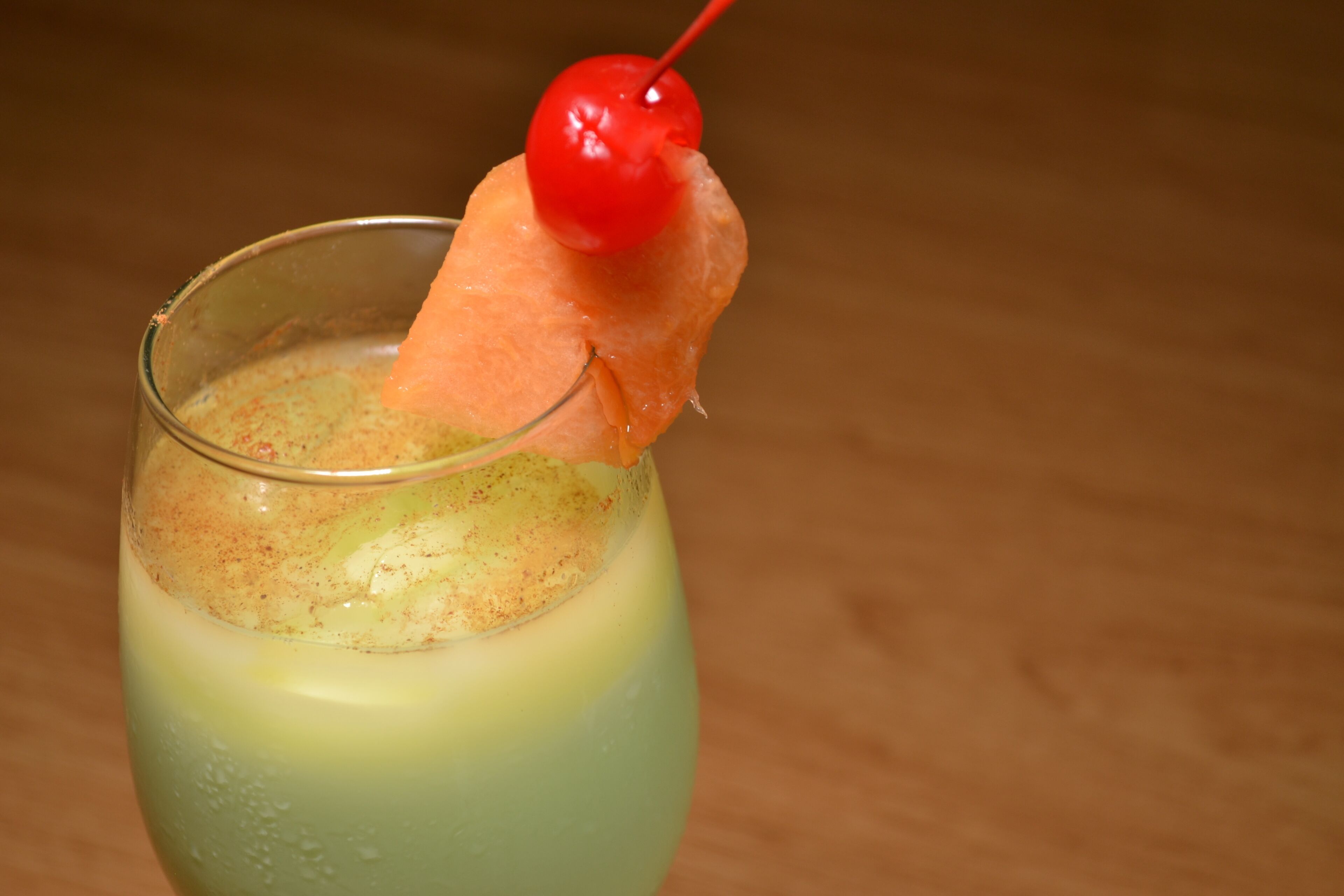A cocktail with a cherry garnish.