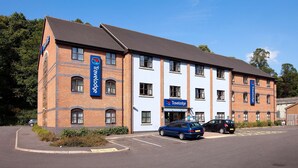 A Travelodge hotel with a brick facade, multiple windows, and a parking lot. - Travelodge Kidderminster (Kidderminster)