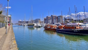 A marina with boats docked along a waterfront promenade. - go2 portishead marina hotel (Bristol)