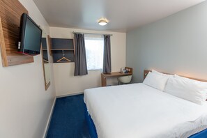 A hotel room with a large bed, a desk with a chair, a television mounted on the wall, and a window with curtains. - go2 portishead marina hotel (Bristol)